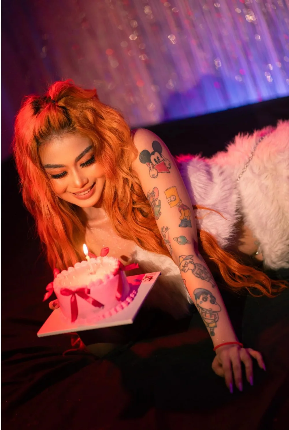 DJ VOCKA with orange hair in a red-lit room
