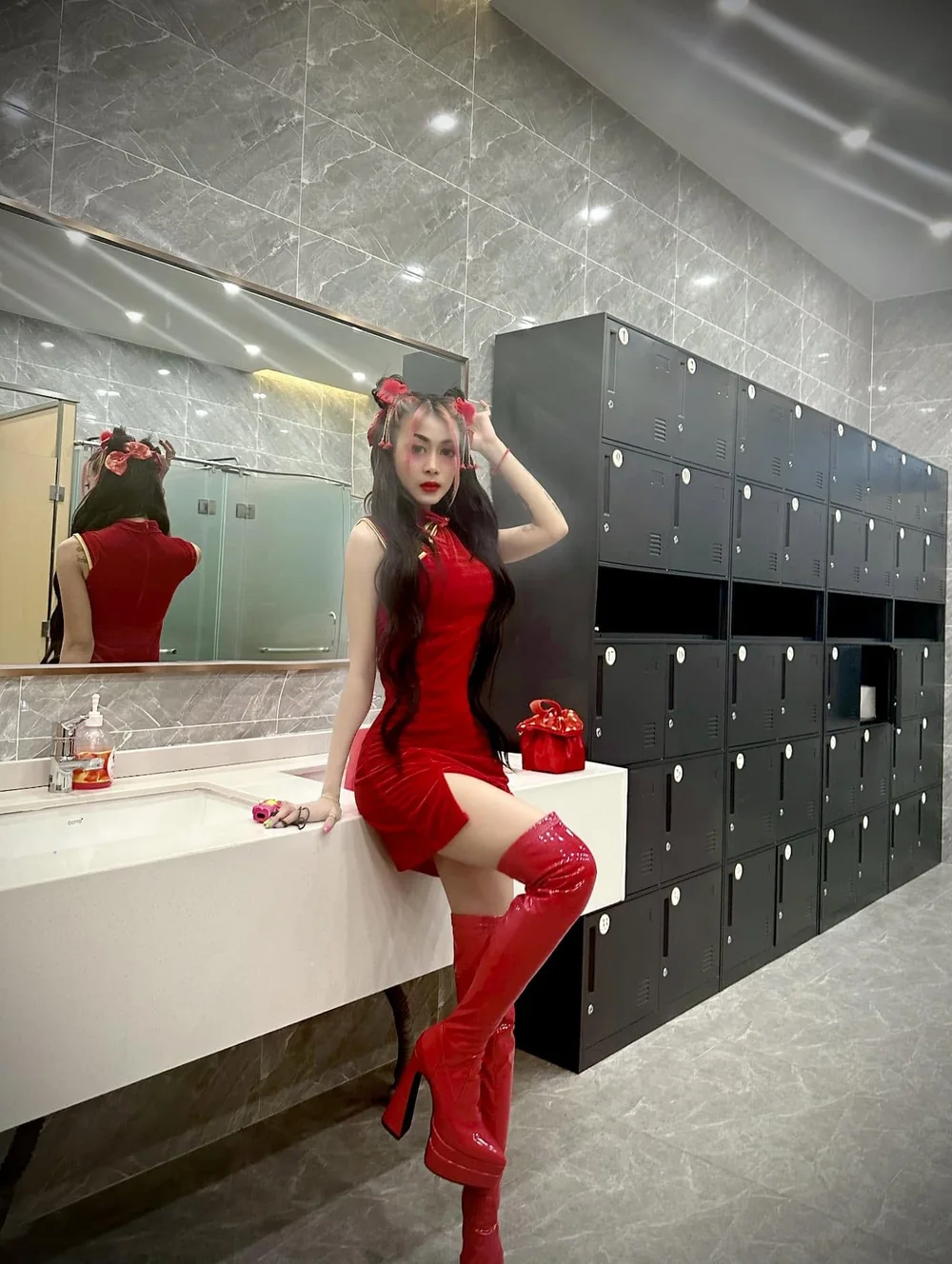 DJ VOCKA in a red dress and red boots